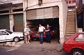 This is an unusual shot. Mike Capon with two lads from the Austin garage in Beirut. We flew a windscreen to the Lebanon and it was in this shack that it was fitted before scrutineering. If anyone knows how to replace glass surely the good folk of Beirut should!